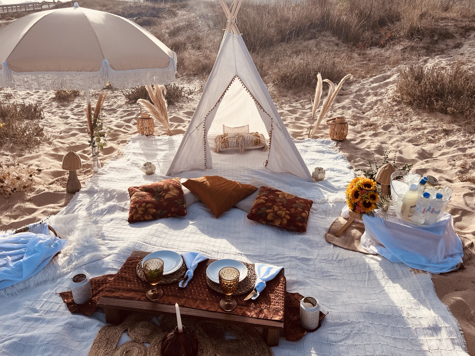 Beach picnic with tipi and cushions